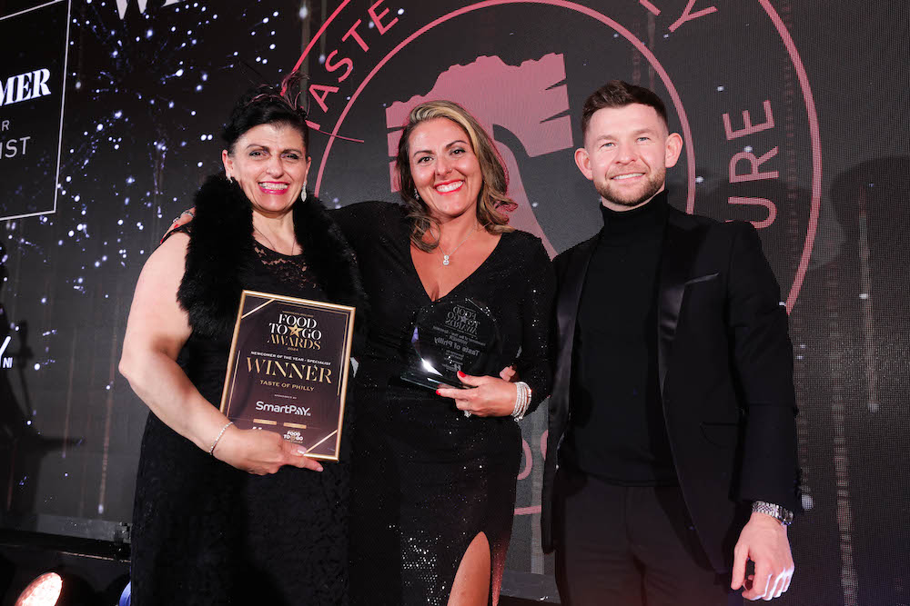 Lisa Crane and Nicole Doyle from Taste of Philly in Lurgan collecting the winner’s trophy for Newcomer of the Year - Specialist from Marc McLaughlin from category sponsor Smart Pay NI